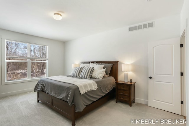 bedroom featuring light colored carpet, visible vents, and baseboards