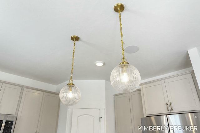 room details featuring decorative light fixtures and gray cabinetry