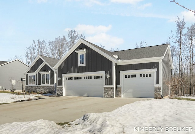 view of front facade with a garage, concrete driveway, and board and batten siding