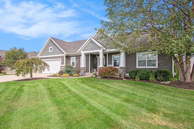 craftsman-style home with a garage, stone siding, a front lawn, and concrete driveway