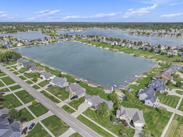 birds eye view of property with a water view and a residential view