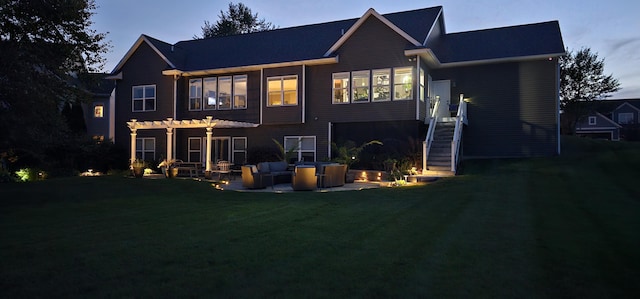 back of property at dusk with stairs, a patio, a lawn, and a pergola