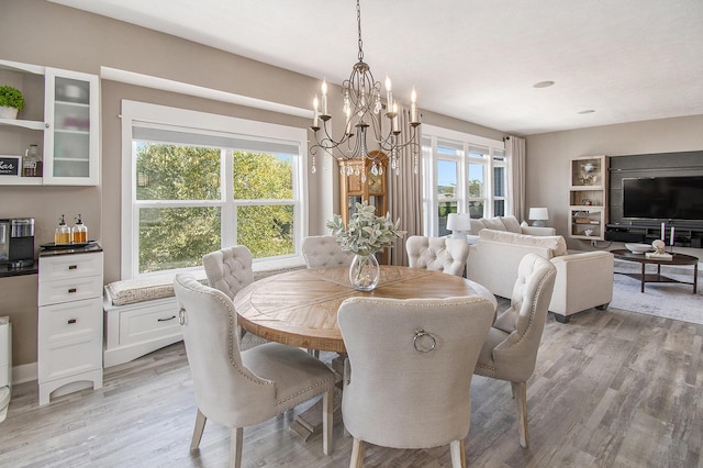 dining area with a notable chandelier and light wood-style floors