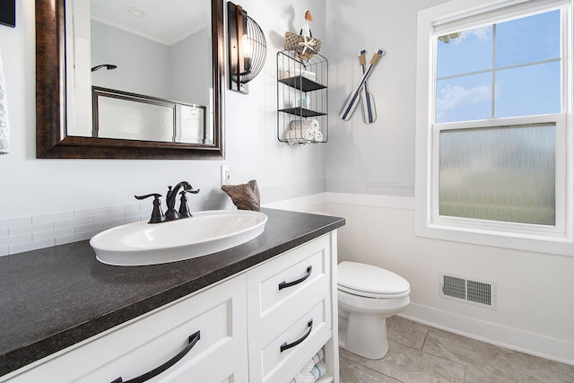 bathroom featuring toilet, visible vents, and vanity