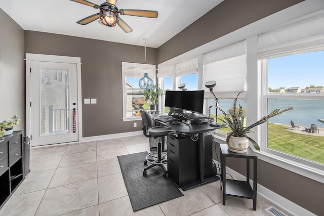 home office featuring light tile patterned floors, plenty of natural light, visible vents, and baseboards