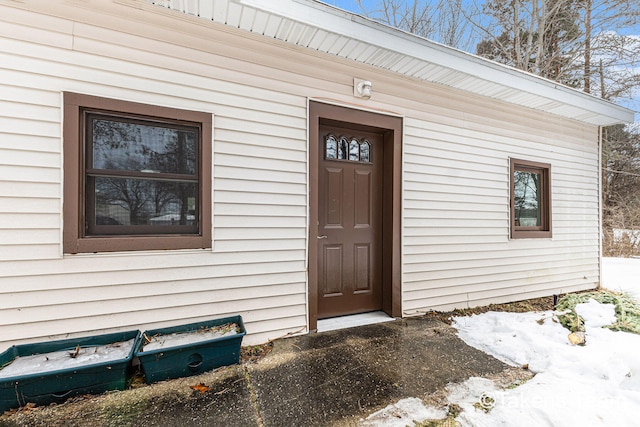 view of snow covered property entrance