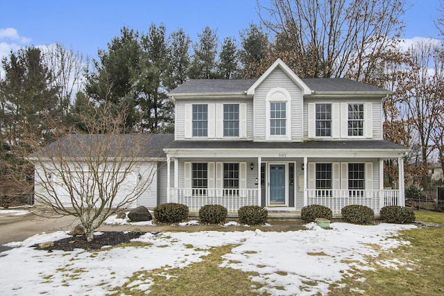 view of front of property featuring a garage and a porch