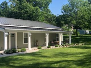 exterior space featuring a porch and a front lawn