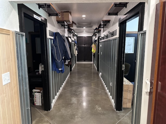 hallway with concrete flooring and a textured ceiling