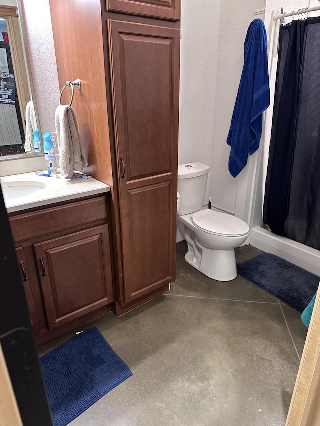 bathroom featuring a textured wall, a shower stall, toilet, and vanity