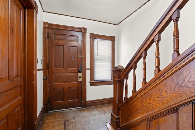 entryway featuring dark wood-style floors, stairway, and baseboards