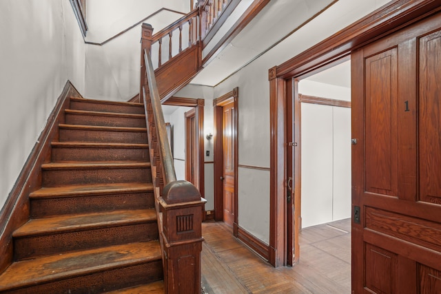 stairway with hardwood / wood-style flooring