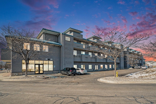 property at dusk with uncovered parking