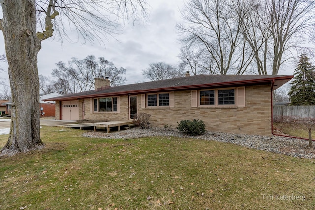 view of front of house featuring a garage, brick siding, fence, a chimney, and a front yard