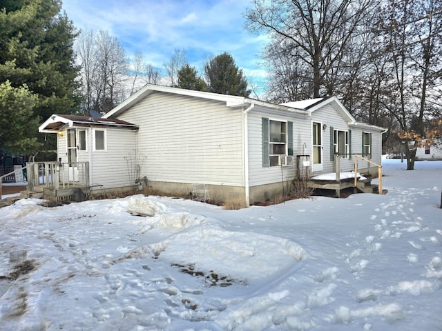 view of snow covered exterior featuring a wooden deck