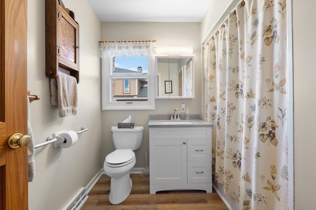 bathroom with toilet, vanity, wood finished floors, a shower with curtain, and baseboards