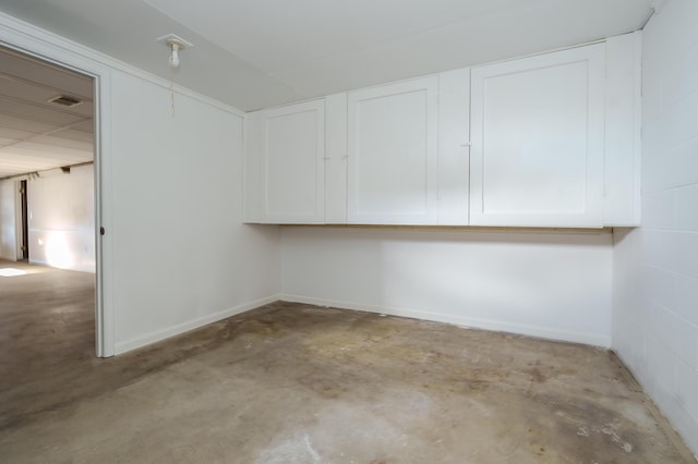 interior space with visible vents and concrete block wall