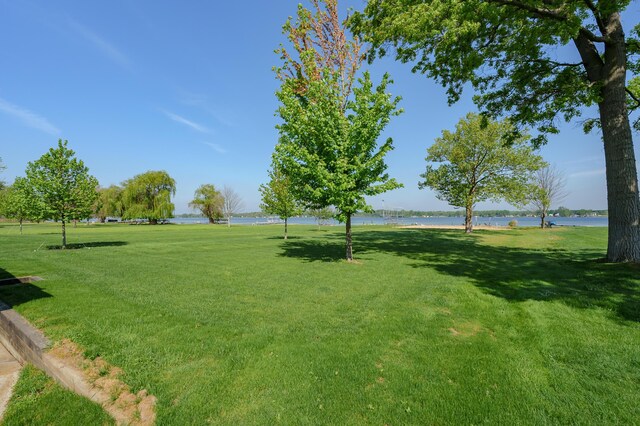 7585 S Indian Lake Dr, Vicksburg, MI 49097 - view of home's community with a water view and a lawn