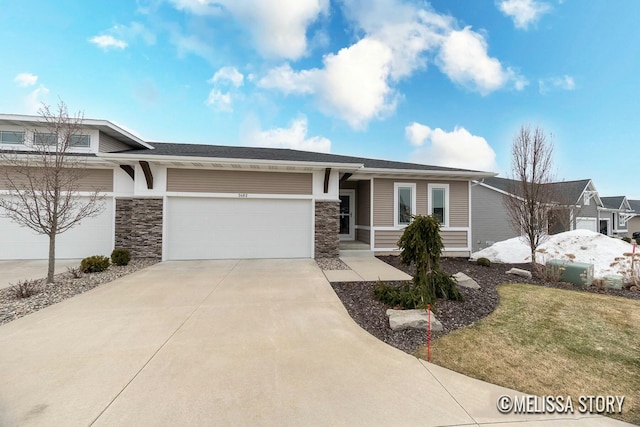 view of front of home featuring a garage, stone siding, driveway, and a front lawn