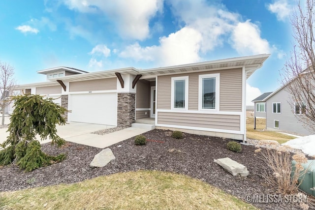 view of front facade featuring a garage, stone siding, and driveway