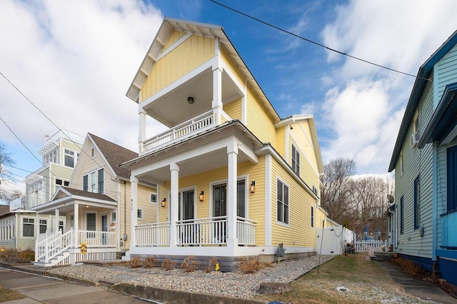 view of front of home with a porch and a balcony