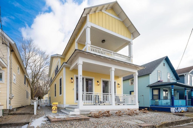 view of front facade with a porch, board and batten siding, and a balcony