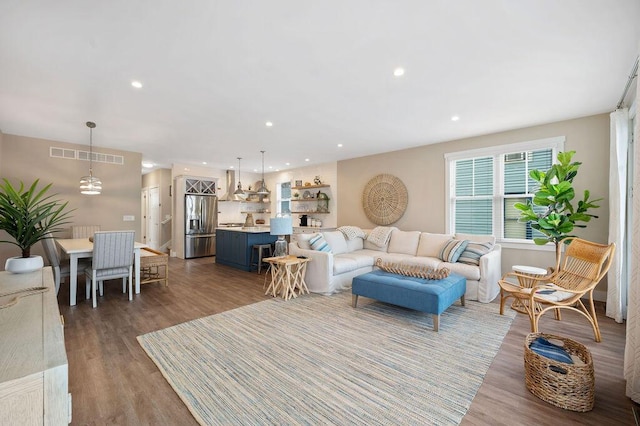 living area featuring wood finished floors, visible vents, and recessed lighting