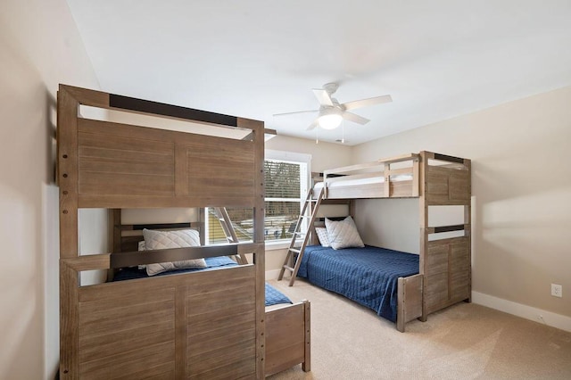 bedroom with light carpet, ceiling fan, and baseboards