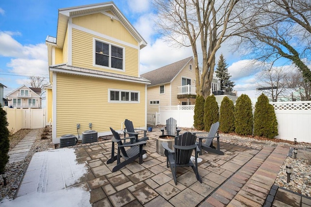 view of patio / terrace with an outdoor fire pit, a fenced backyard, and central air condition unit