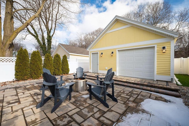 detached garage featuring fence