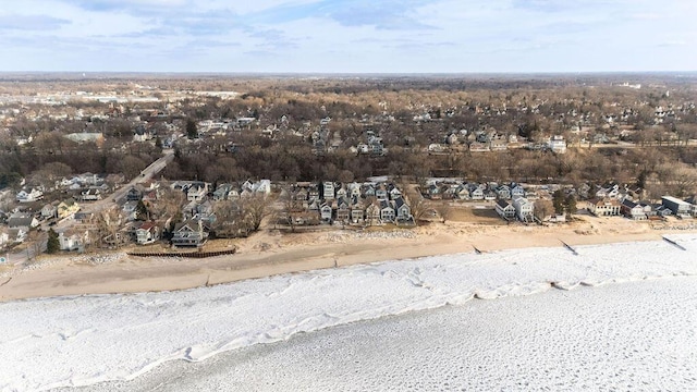 birds eye view of property with a water view, a residential view, and a beach view