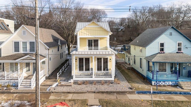 rear view of house featuring a porch