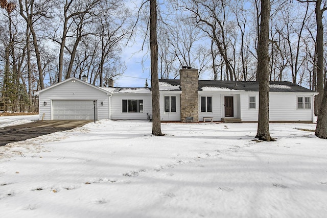 ranch-style house featuring a chimney and an attached garage