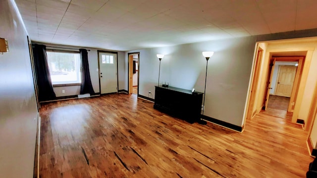 interior space featuring baseboards and wood finished floors