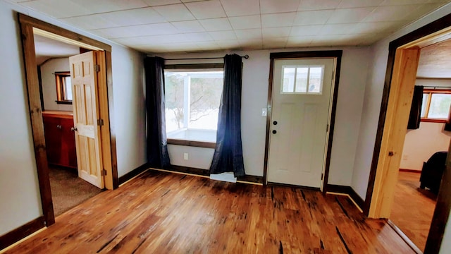 entrance foyer featuring baseboards and wood finished floors