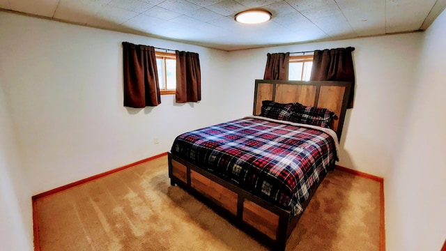 bedroom with carpet floors and baseboards