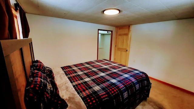 bedroom with carpet floors and baseboards