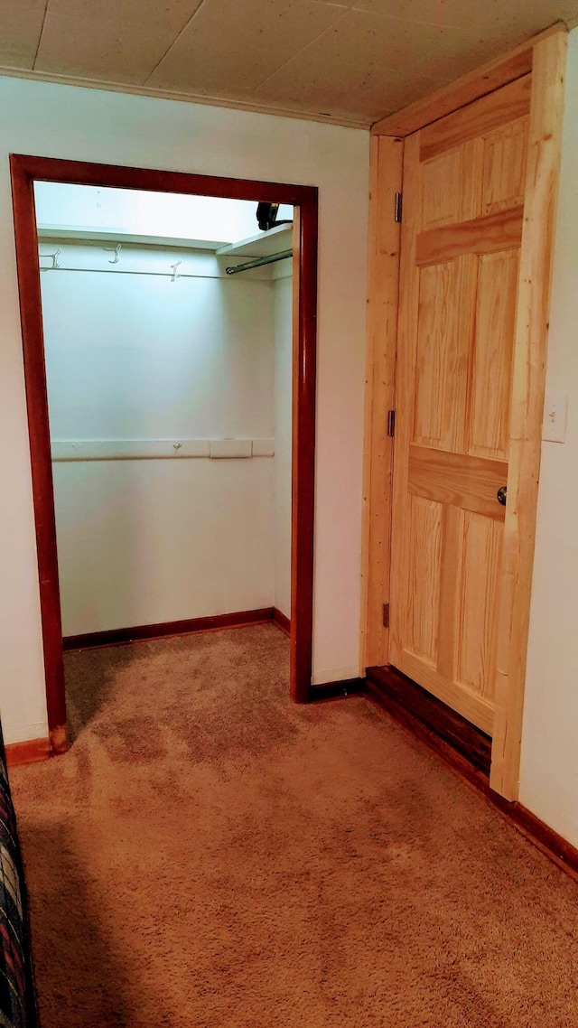 unfurnished bedroom featuring carpet floors and baseboards