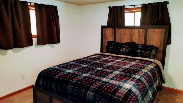 bedroom featuring carpet and baseboards