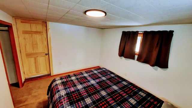 bedroom featuring carpet and baseboards