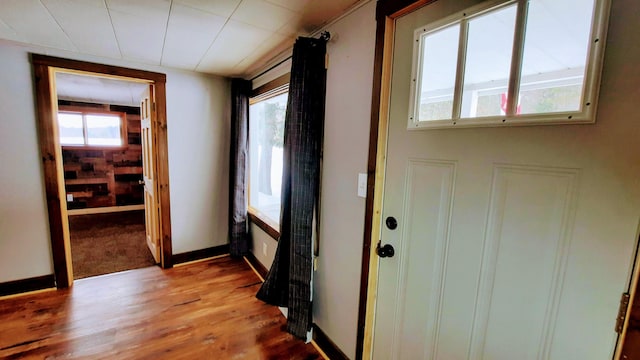 interior space with wood finished floors and baseboards