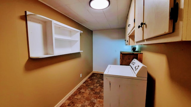 laundry room with washer / clothes dryer, cabinet space, stone finish floor, and baseboards