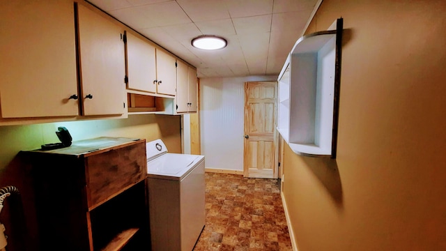 laundry area with stone finish floor, cabinet space, baseboards, and washer / clothes dryer