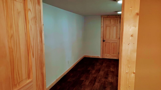 hall featuring wood finished floors and baseboards