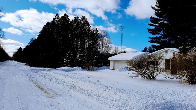 yard covered in snow featuring an attached garage