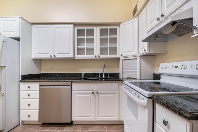 kitchen with white appliances, white cabinetry, a sink, and under cabinet range hood