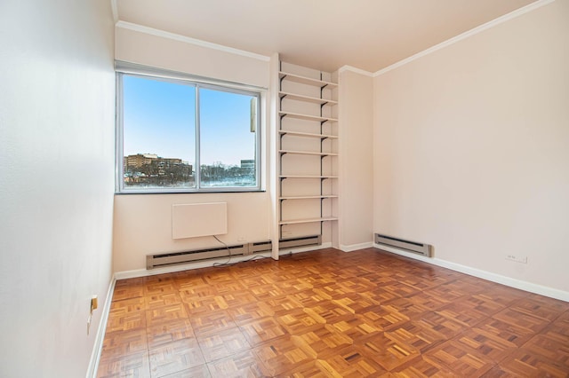 spare room featuring a baseboard heating unit, crown molding, and baseboards