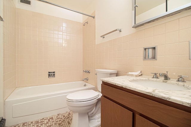 bathroom with shower / bath combination, toilet, vanity, a baseboard heating unit, and tile walls