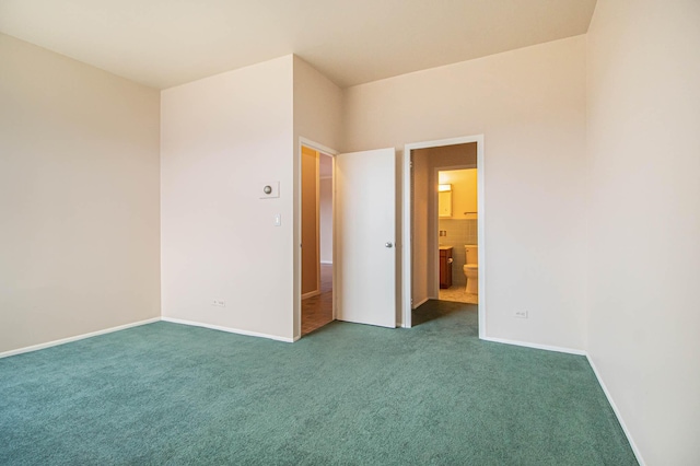 unfurnished bedroom with carpet floors, ensuite bath, and baseboards