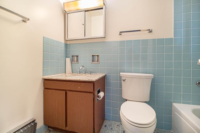 bathroom with tile patterned flooring, toilet, visible vents, vanity, and tile walls